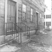 SA0377 - Photo shows the meeting house in the course of being dismantled, including detail of iron railings and steps to two doors. E.D. Andrews bought interior woodwork. Identified on the back.